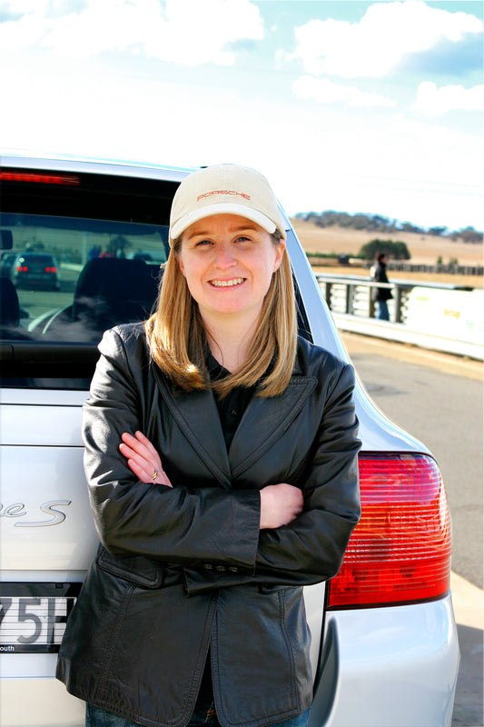 Amanda Lintott, Founder Autonomy car products and accessories pictured smiling with her arms crossed and her back to a car