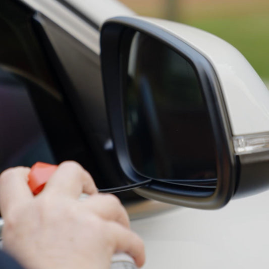 spray can being directed to car side mirrior