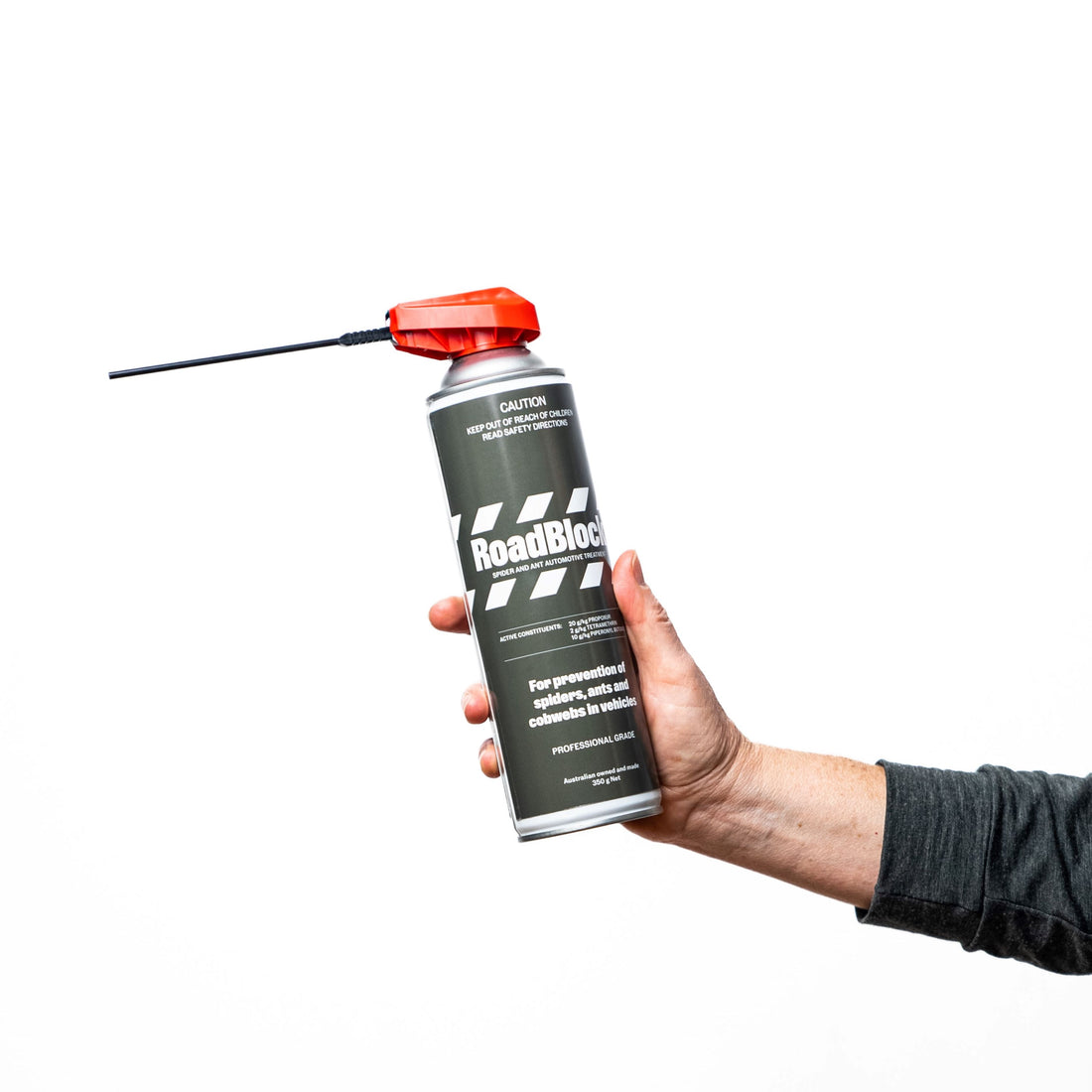 autonomy roadblock spray pictured with a person holding it up on a white background