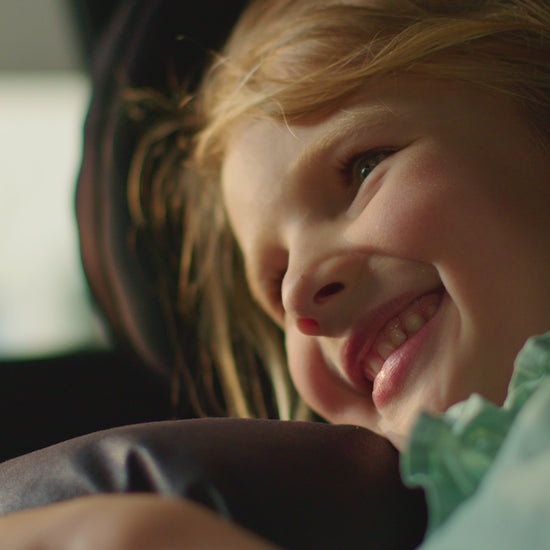 little girl smiling holding her autonomy travel pillow video