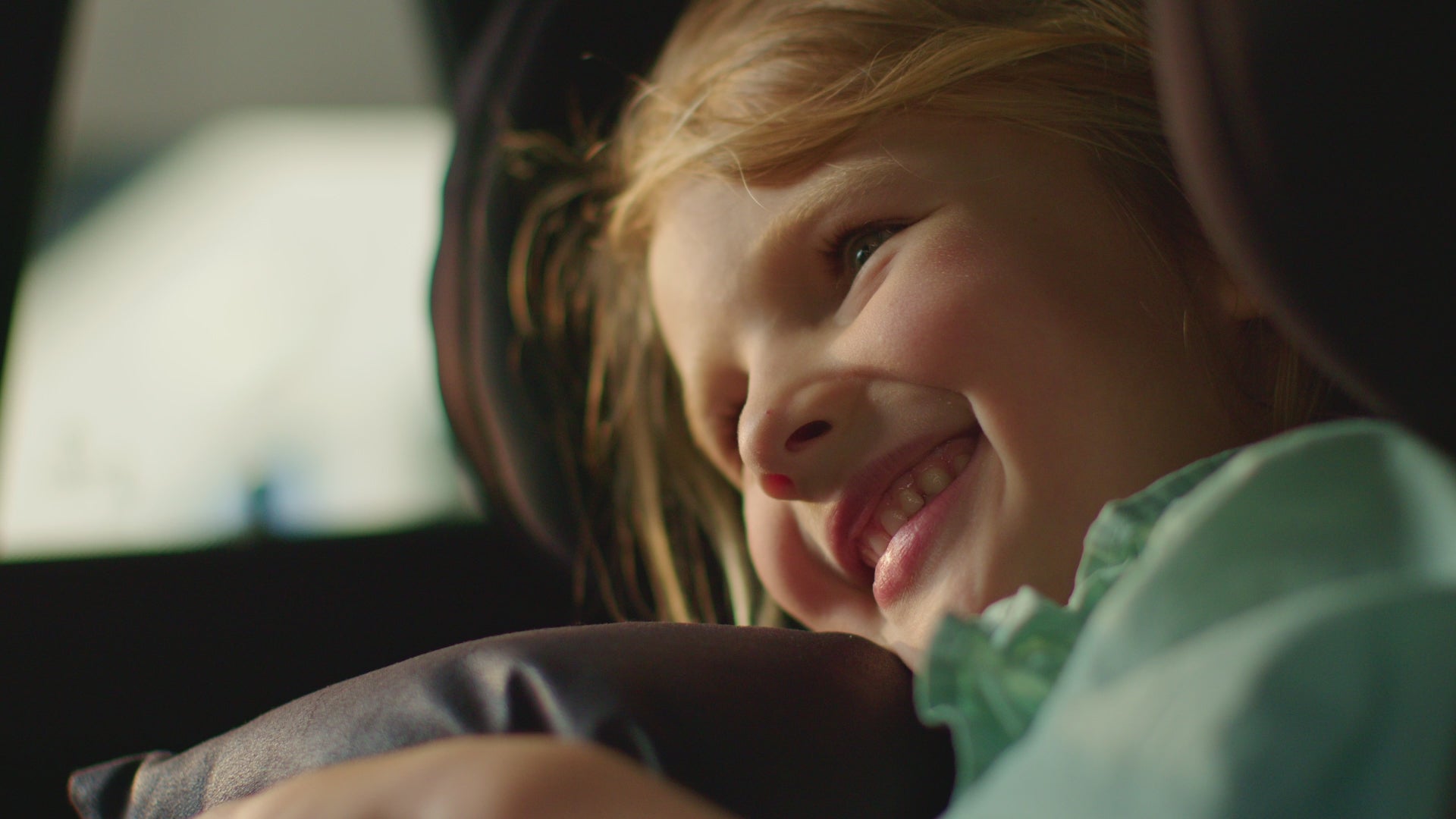 little girl smiling holding her autonomy travel pillow video