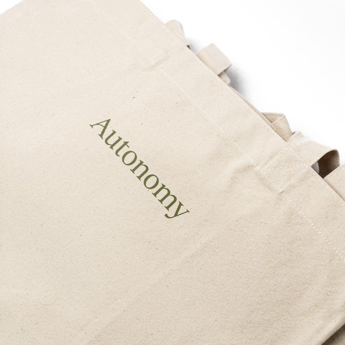 zoomed in picture of the autonomy tote bag angled on a white background